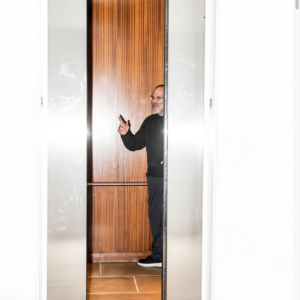 Scott Rudin inside an elevator as door closes Photo by Krista Schlueter for The New York Times